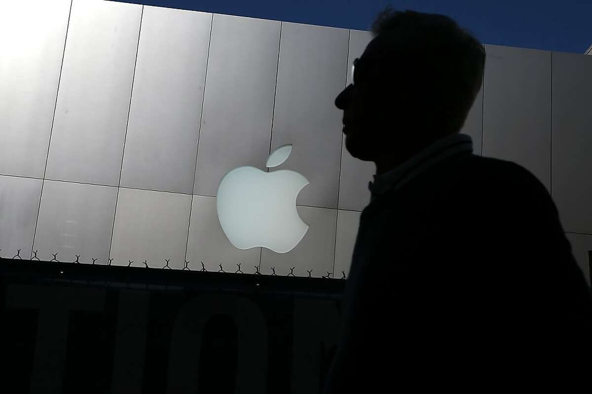 SAN FRANCISCO, CA - APRIL 23: A person walks by an Apple Store on April 23, 2013 in San Francisco, California. Analysts believe that Apple Inc. will report their first quarterly loss in nearly a decade as the company prepares to report first quarter earnings today after the closing bell. (Photo by Justin Sullivan/Getty Images) *** BESTPIX ***