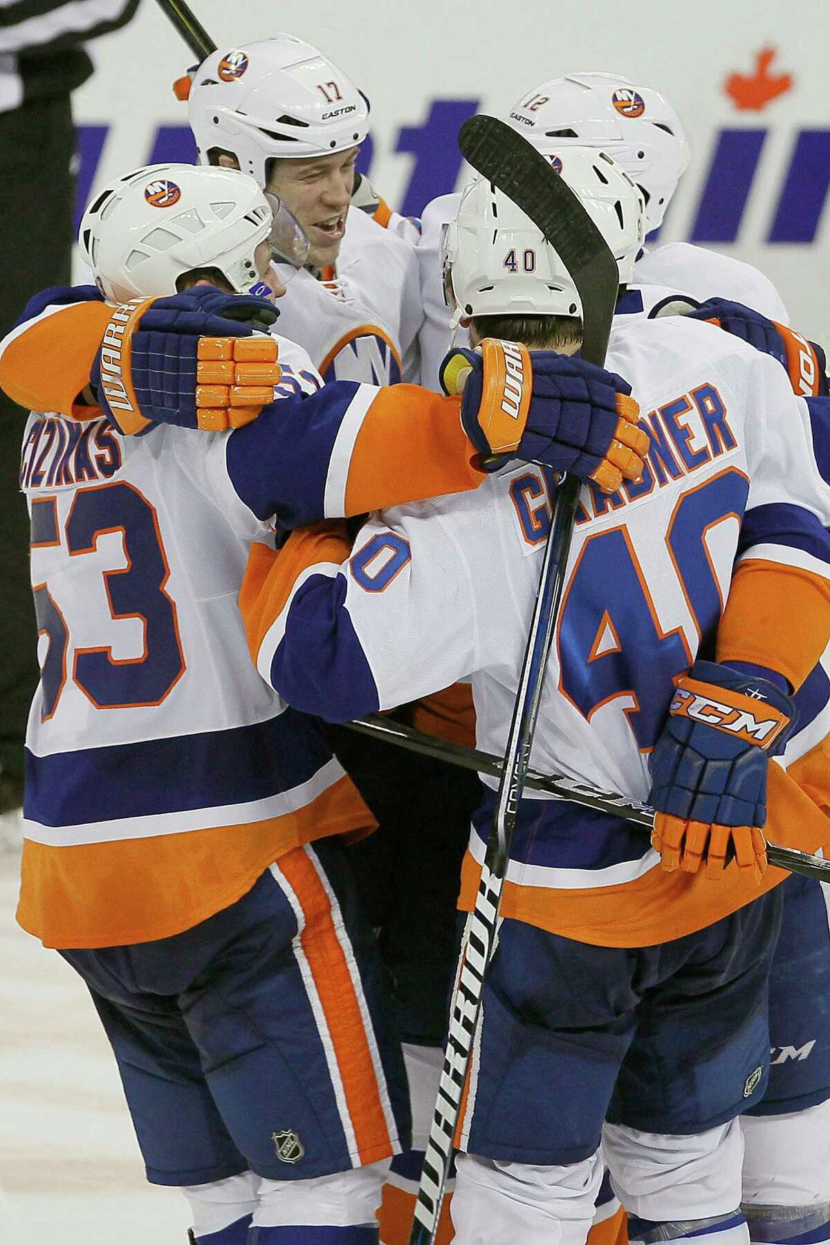 New York Islanders' Casey Cizikas (53), Matt Martin (17), Josh Bailey (12) and Michael Grabner (40) celebrate a shootout win over the Winnipeg Jets in an NHL hockey game in Winnipeg, Manitoba, Saturday, April 20, 2013. Cizikas played part of the season with the Sound Tigers. (AP Photo/The Canadian Press, John Woods)