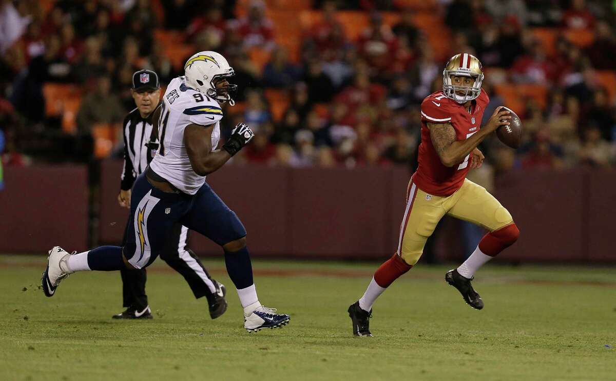 San Francisco 49ers quarterback Colin Kaepernick (7) scrambles from San Diego Chargers defensive end Kendall Reyes (91) during the first half of an NFL preseason football game in San Francisco, Thursday, Aug. 30, 2012. (AP Photo/Marcio Jose Sanchez)
