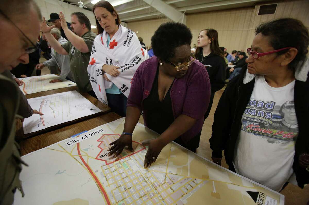 Residents of West, TX look at desaster map of their town, at a town hall meeting held at the Knights of Columbus Hall for residents of West, TX, affected by the recent blast, on Tuesday April 23, 2013.