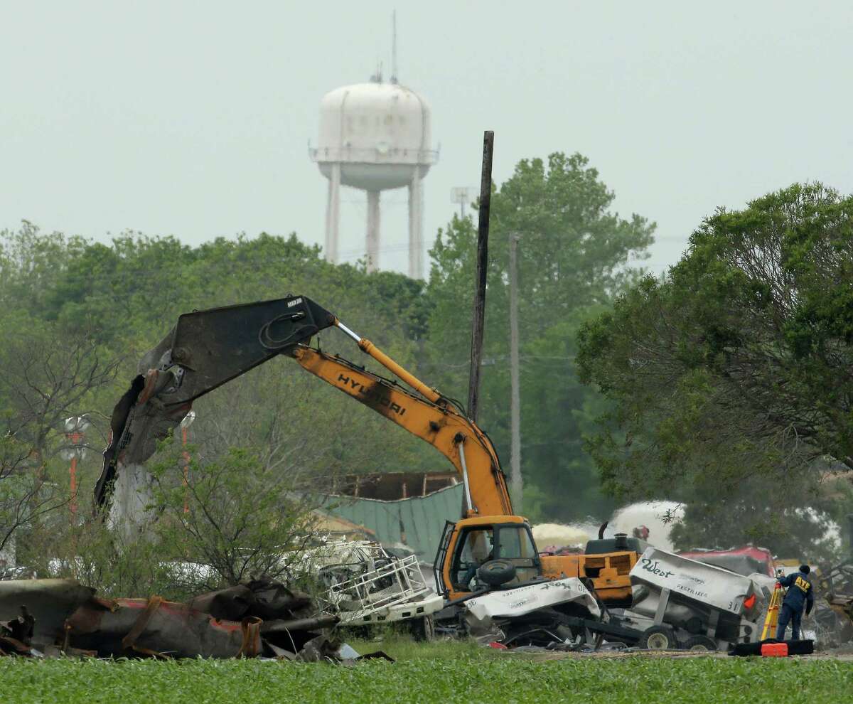 Heavy equipment is put to work Tuesday at the site of the fertilizer plant explosion in West, nearly a week after a massive blast at the local fertilizer plant killed 14 and forced many of the town's families from their homes.