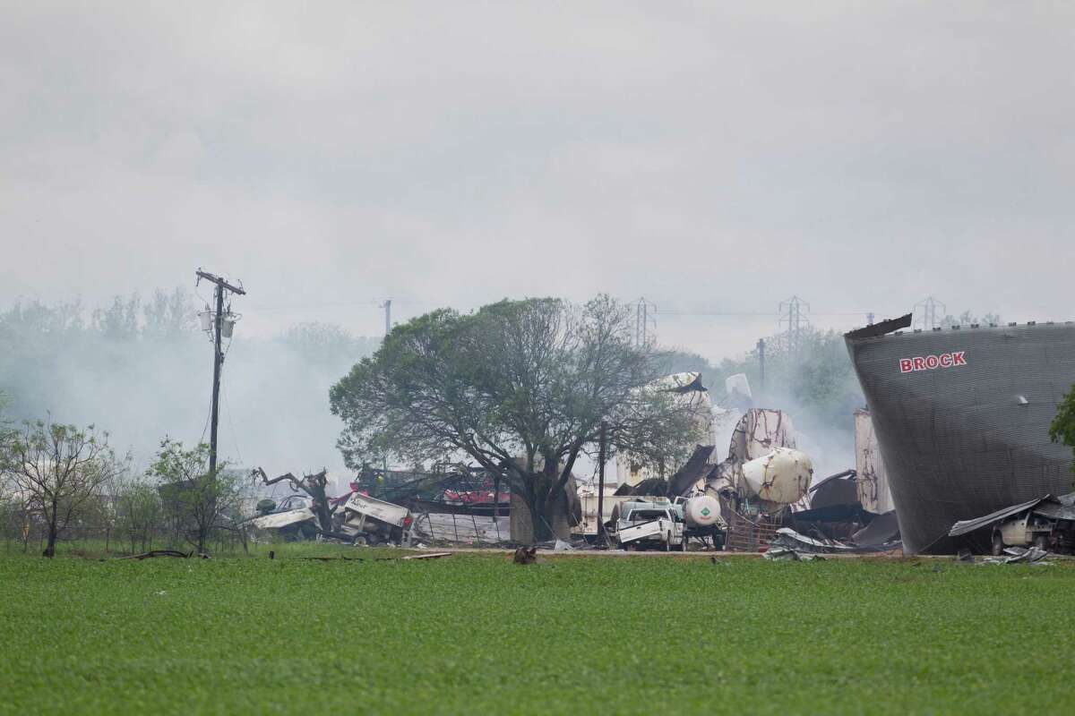 The West Fertilizer Co. plant smolders on Thursday, the day after a massive explosion at the rural facility killed 14 people.