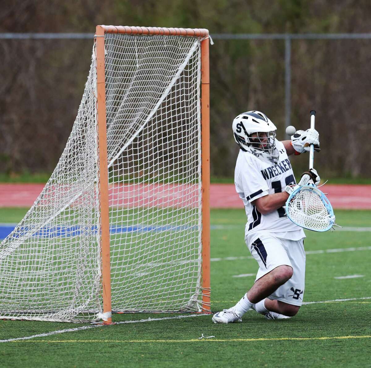 Mike Ross Connecticut Post freelance -Staples High School's goalie #12 Cole Gendels protects the goal and make a save during Tuesday afternoon match-up against Darien High School.
