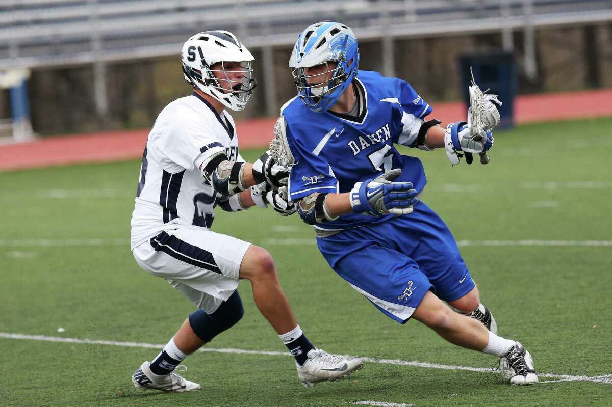 Mike Ross Connecticut Post freelance -Darien High School's # 5 Harry Gillespie works the ball upfield against Staples High School's #23 Jack Greenwald during Tuesday afternoon match-up at Staples High School.