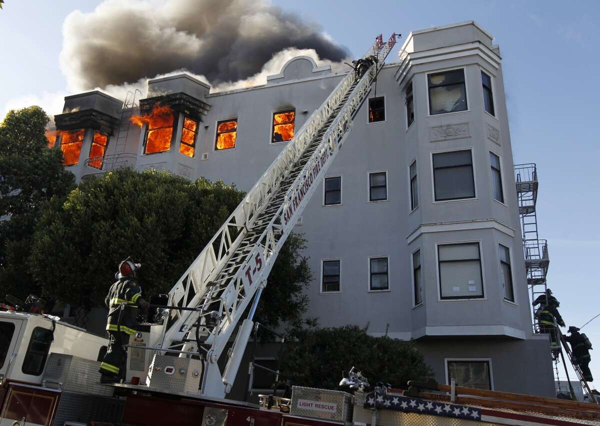Firefighters battle a four-alarm fire at Pierce Street and Golden Gate Avenue in San Francisco, Calif. on Thursday, Dec. 22, 2011.