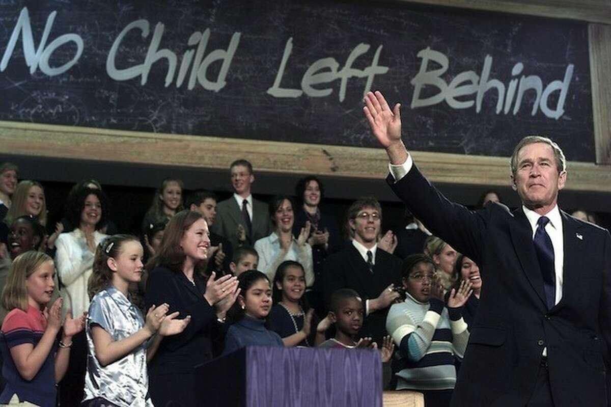 George W. Bush signs "No Child Left Behind" into law. Getty Images.