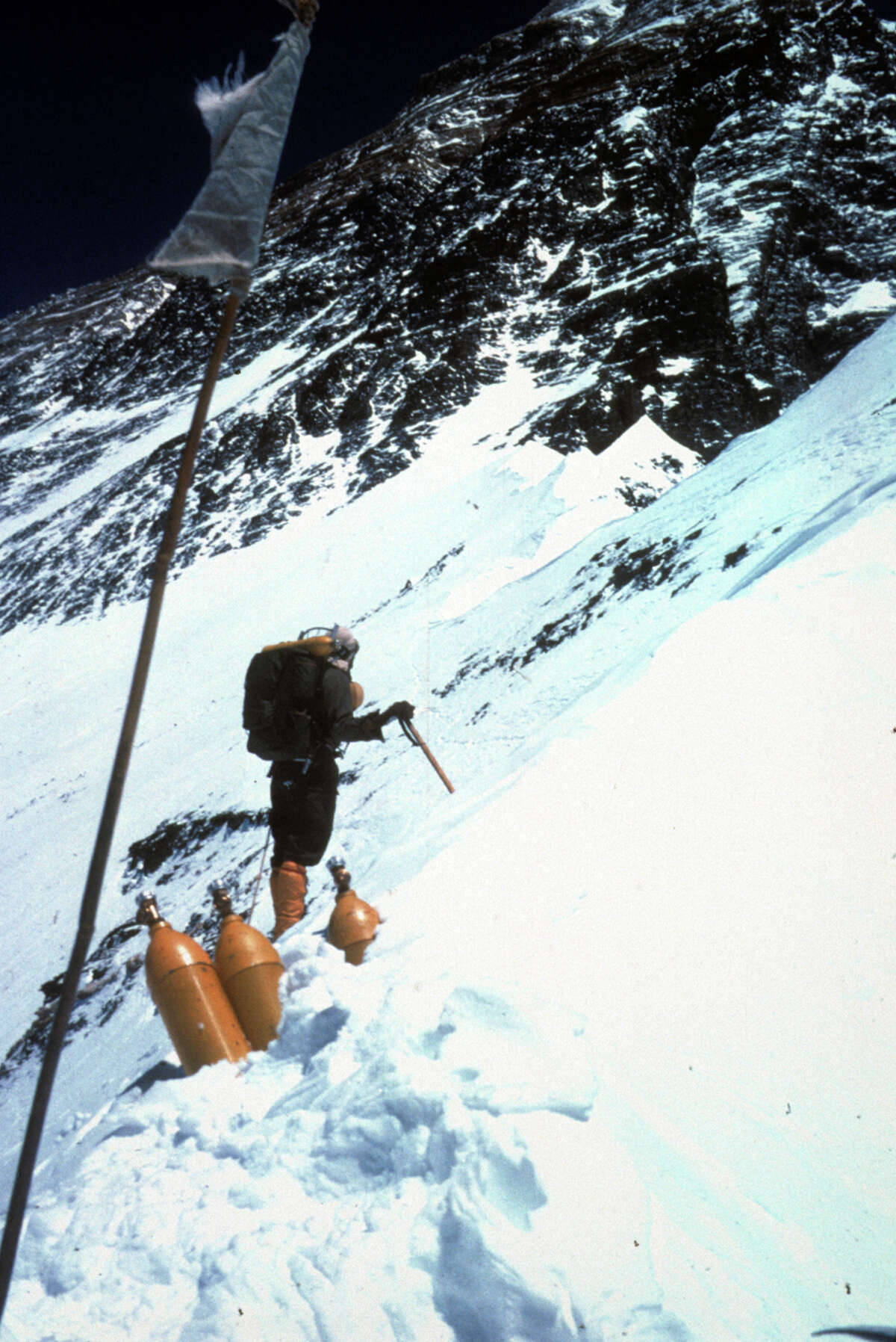 Prayer flags, Willi Unsoeld, oxygen bottles, and Mt. Everest.