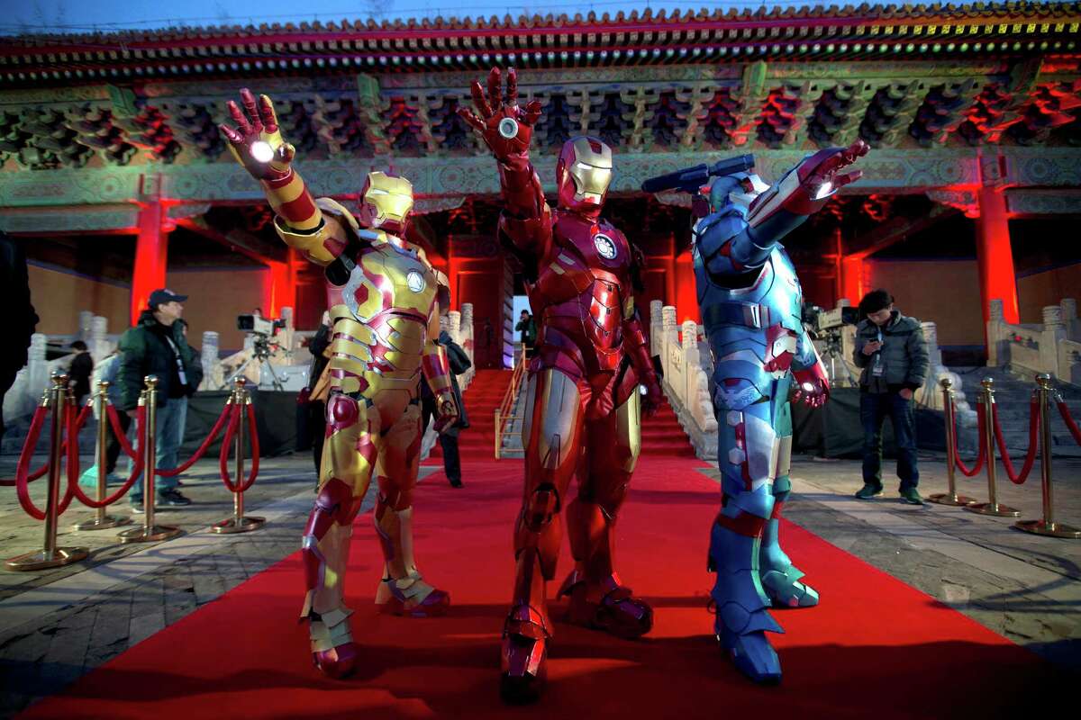 Chinese performers dressed as Iron Man pose for photos in Beijing’s Forbidden City.