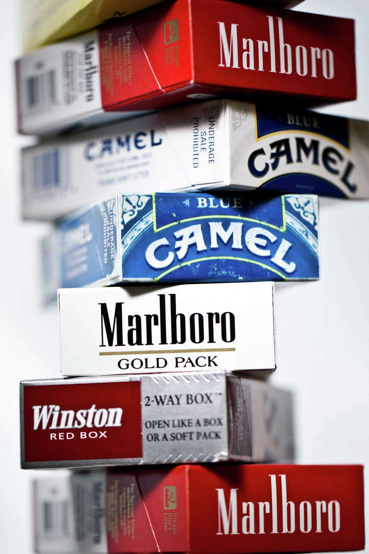 Various packs of cigarettes are arranged for a photograph in New York, U.S., on Thursday, April 14, 2011. Tobacco companies, including Altria Group Inc.'s Philip Morris USA unit, asked a judge last month to dismiss the federal government's 1999 racketeering case, saying court oversight of the industry is no longer needed. Photographer: Chris Goodney/Bloomberg