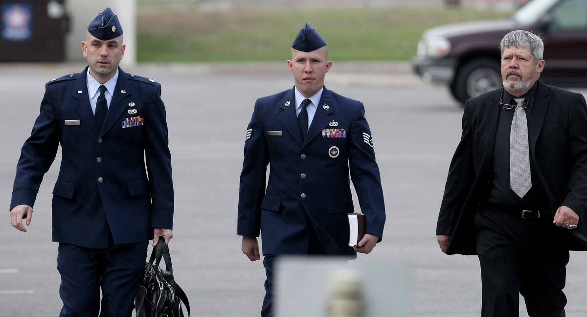 U.S. Air Force Staff Sergeant Robert Hudson (center) walks at Joint Base San Antonio-Lackland Thursday April 25, 2013. The training instructor is accused of having sex with a technical school trainee and other charges.