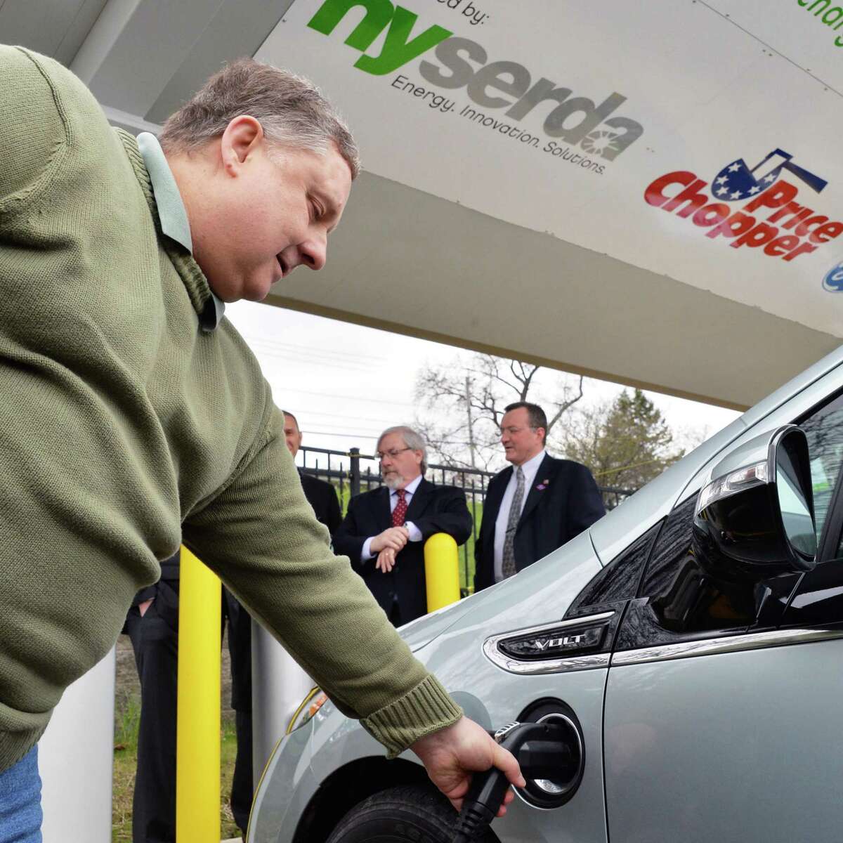 Rick Lipinskas of Guilderland plugs his Chevy Volt into at the new electric vehicle charging stations at the Price Chopper store on Balltown Road in Mohawk Commons in Niskayuna, NY Thursday April 25, 2013. (John Carl D'Annibale / Times Union)