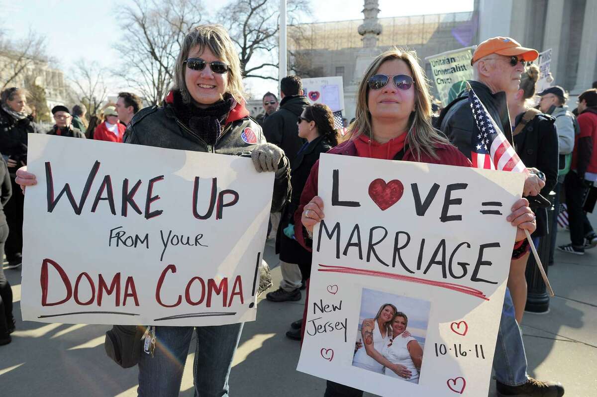 Same-sex marriage supporters demonstrate in front of the Supreme Court on March 27, 2013 in Washington, DC. The rights of married same-sex couples will come under scrutiny at the US Supreme Court on Wednesday in the second of two landmark cases being considered by the top judicial panel. After the nine justices mulled arguments on a California law that outlawed gay marriage on Tuesday, they will take up a challenge to the legality of the Defense of Marriage Act (DOMA). The 1996 law prevents couples who have tied the knot in nine states -- where same-sex marriage is legal -- from enjoying the same federal rights as heterosexual couples. AFP PHOTO/Jewel SamadJEWEL SAMAD/AFP/Getty Images