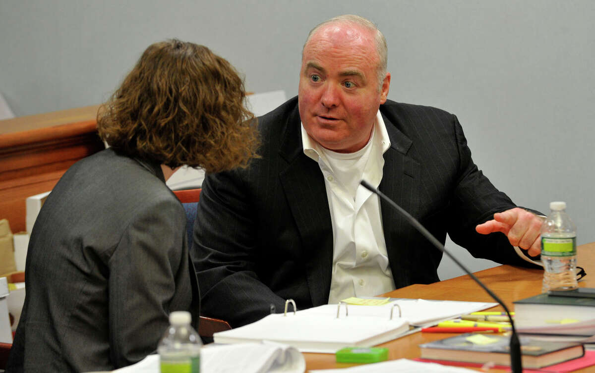 Michael Skakel, right, talks to Jessica Santos, one of his defense attorneys, at Skakel's habeas corpus trial at State Superior Court in Vernon, Conn., on Friday, April 26, 2013.