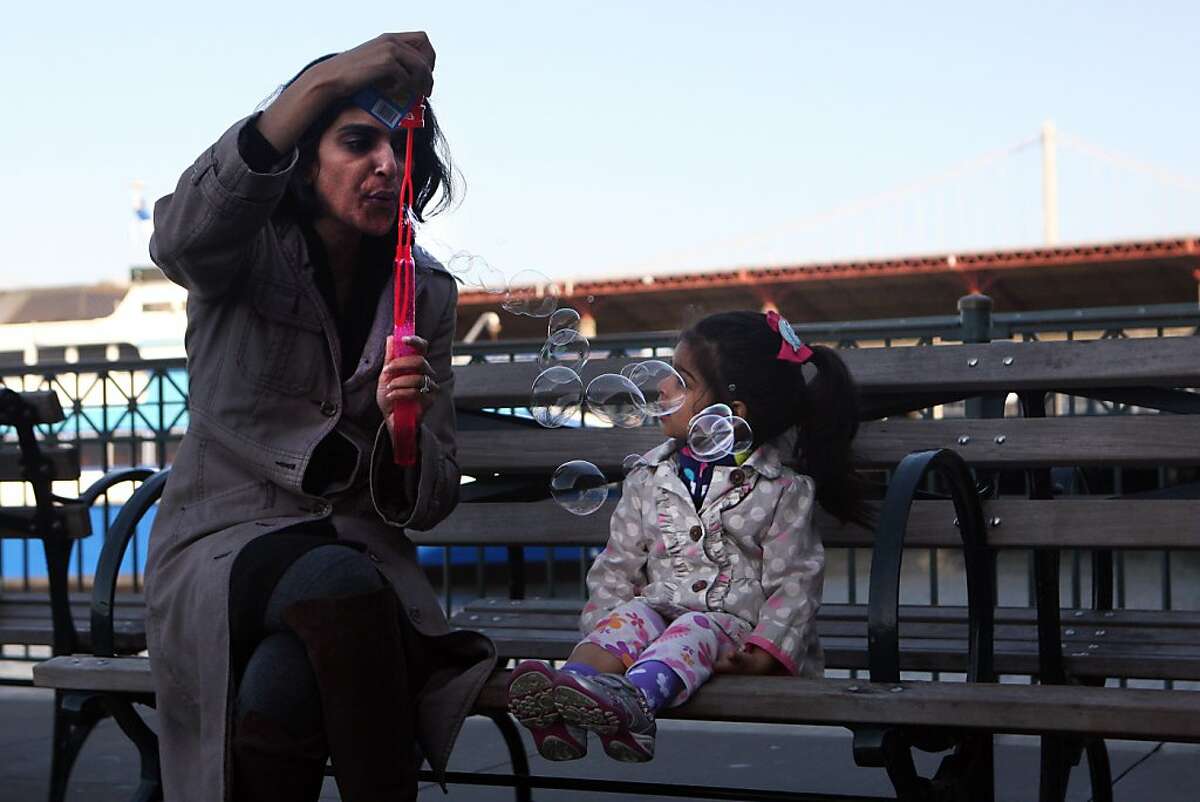 Ariah, 2, and her mother blow bubbles at the San Francisco Ferry Building on April 26, 2013 in San Francisco, Calif. The Port of San Francisco is celebrating 150 years.