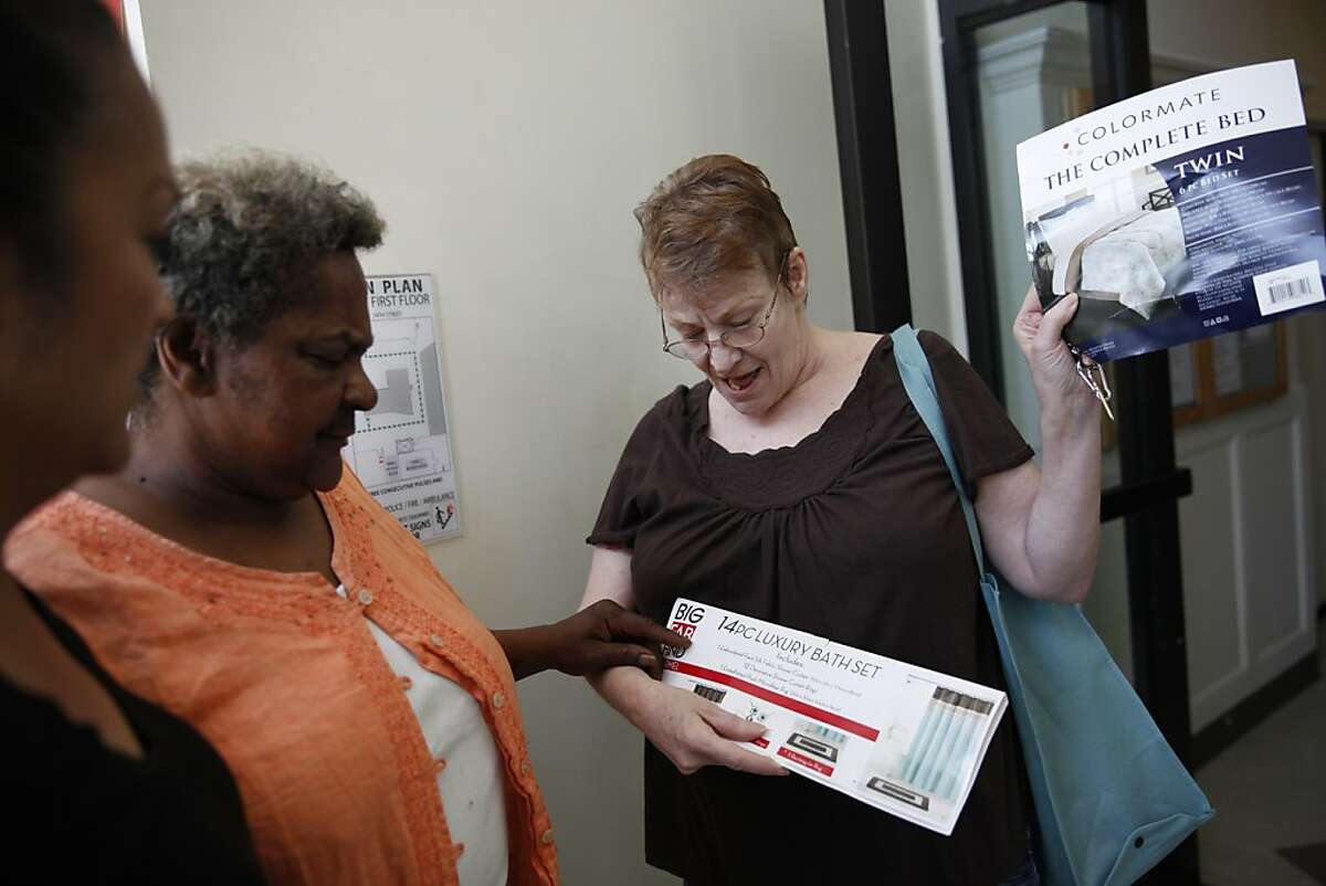 Harrison Hotel resident Linda Lineberry (right) , 65, shows fellow resident Valerie Simmons (center), and Lifelong clinical case manager Cecilia Esguerra (left) items she is considering to furnish her new room at the Harrison Hotel on Friday, April 12, 2013 in Oakland, Calif.