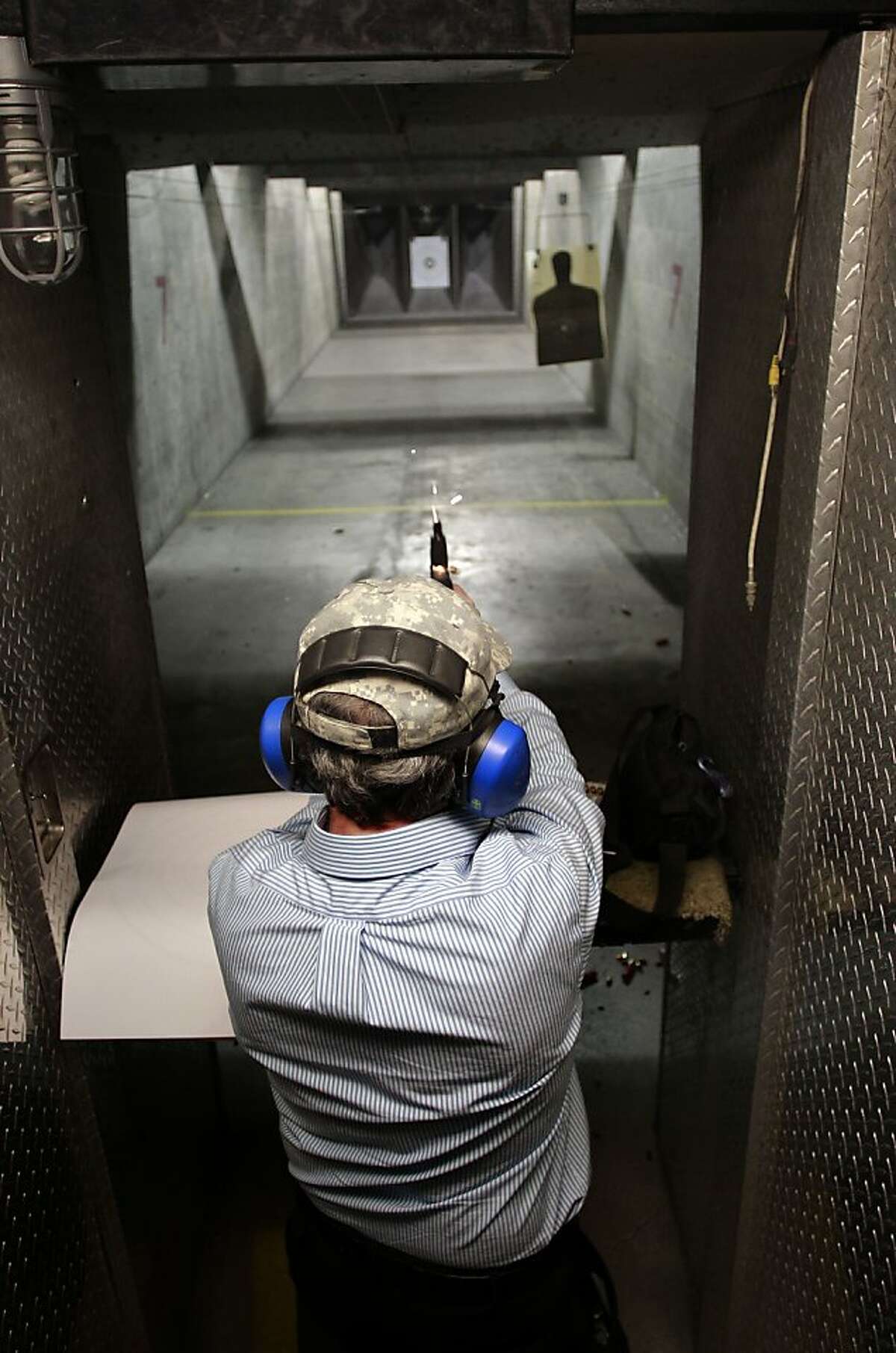 Local gun owner Jeff Levinger, fires his 9mm pistol while taking target practice at the Jackson Arms shooting range in South San Francisco.