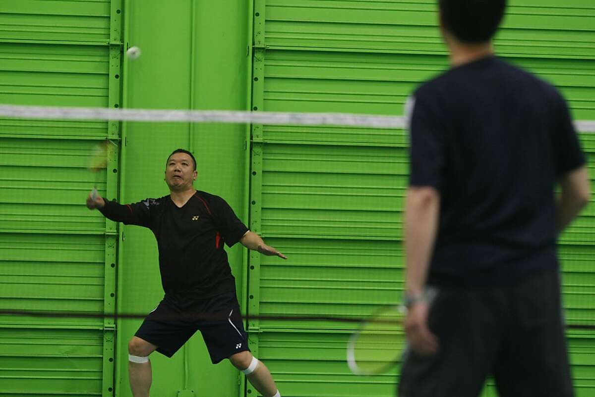 Ray Ng returns the birdie at the California Badminton Academy in Fremont, Calif. on Saturday April 27 2013. Badminton is the first event of the Bay Area Senior Games which takes place over six weeks