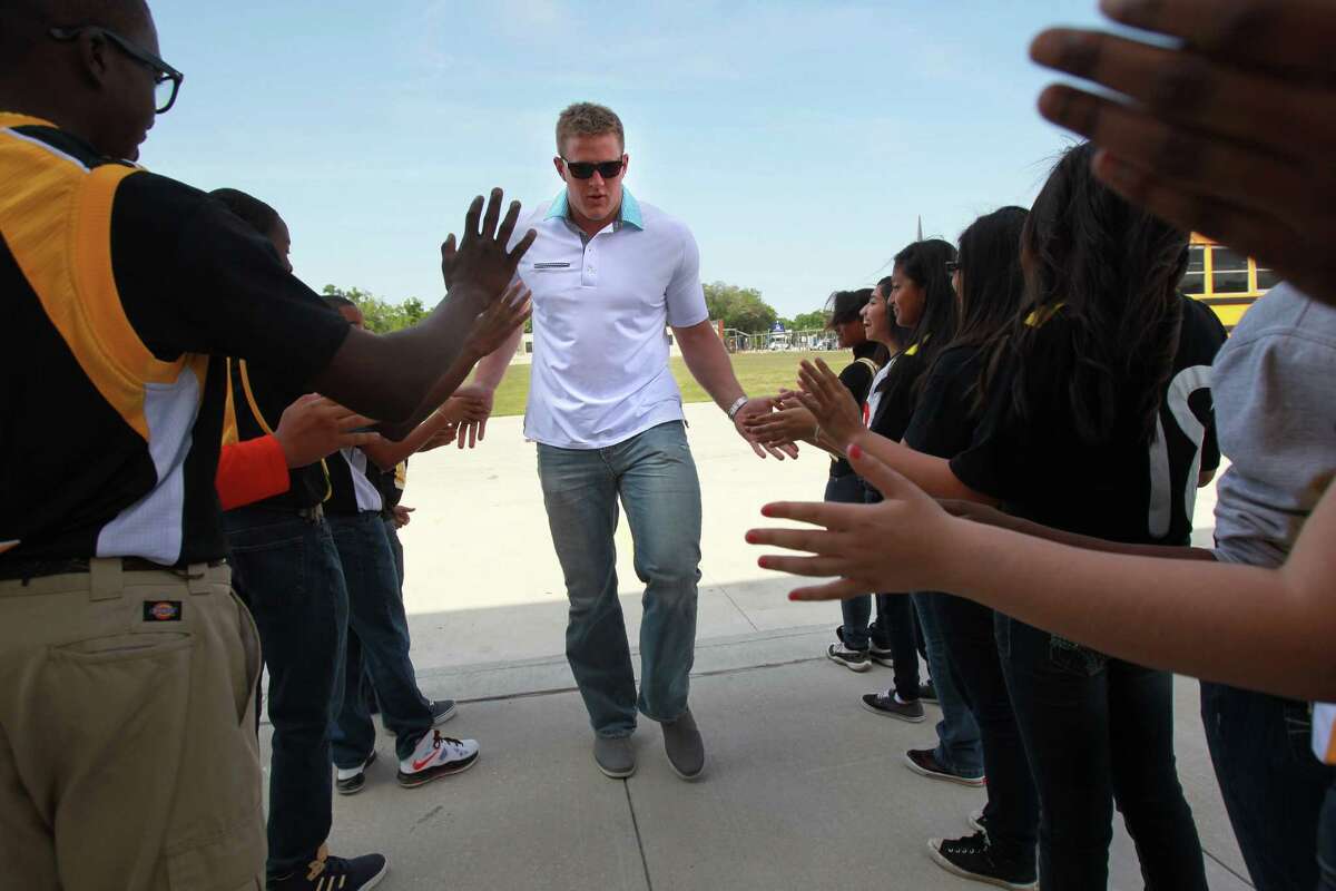 KIPP Liberation College Preparatory School students line up to greet J.J. Watt on Thursday after his foundation donated $60,000 for athletic equipment.