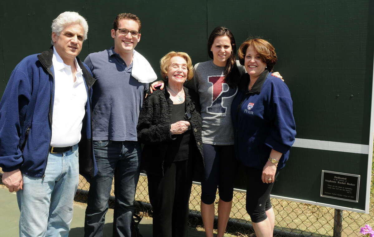 Stephanie Becker's family, from left, her father Jonathan, brother Michael, grandmother Joan Rubenstein, sister Julie and mother Patti, gather at Westhill High School next to a plaque in her honor on the new backboard at the tennis courts in Stamford Conn., April 28, 2013. Becker was an academic and athletic standout during her years at Westhill, she committed suicide last year.