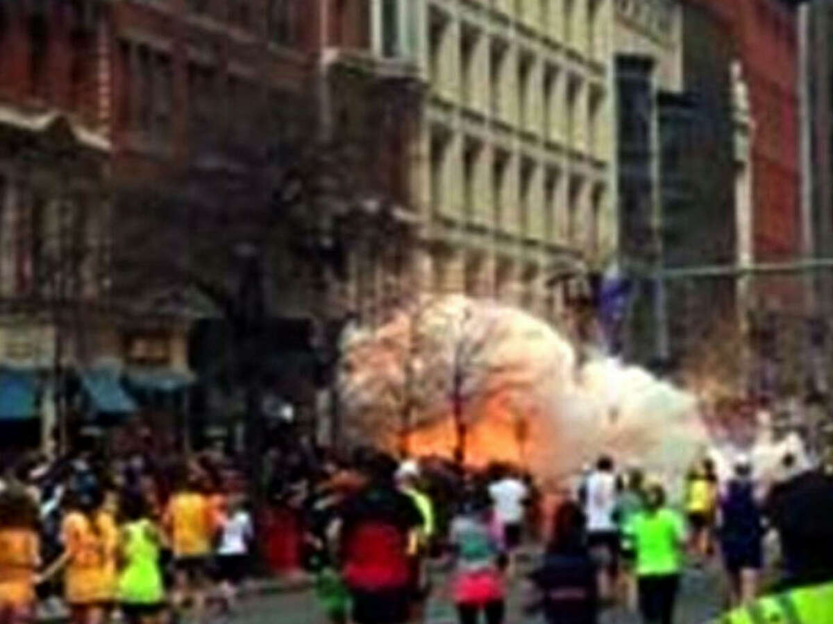 In this image from video provided by WBZ TV, spectators and runners run from what was described as twin explosions that shook the finish line of the Boston Marathon, Monday, April 15, 2013, in Boston. Two explosions shattered the euphoria of the Boston Marathon finish line on Monday, sending authorities out on the course to carry off the injured while the stragglers were rerouted away from the smoking site of the blasts. (AP Photo/WBZTV) MANDATORY CREDIT