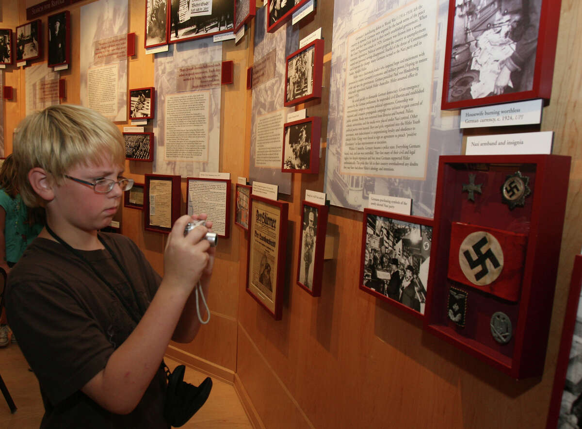 James Rheinlaender,11, takes a picture while looking at exhibits at the Holocaust Memorial Museum of San Antonio Thursday May 27, 2010. JOHN DAVENPORT/jdavenport@express-news.net