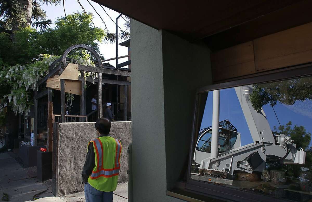 A large crane was used to lift a three ton A-frame put into place on the front porch of Chez Panisse in Berkeley, Calif. on Tues. April 30, 2013. The rebuilding of Chez Panisse with the goal of keeping the iconic Craftsman-style building true to it's original look after a fire closed down the restaurant.