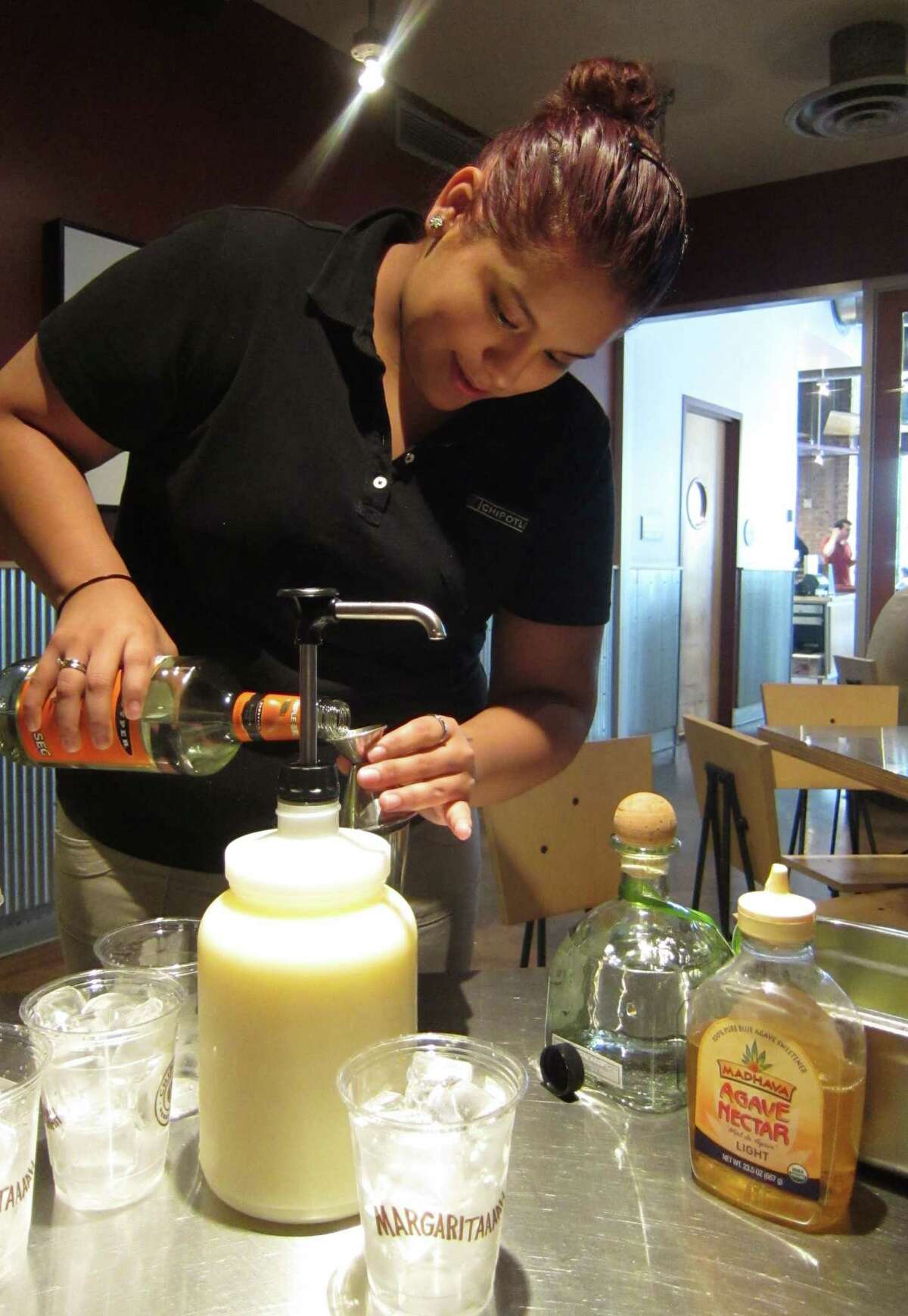 Sandra Maya, manager of the Chipotle Mexican Grill at 909 Texas Ave., makes a hand-shaken magarita with Patron tequila, agave nectar, Triple sec and fresh citrus juice. The top shelf magaritas will be rolled out nationally beginning April 29, 2013.