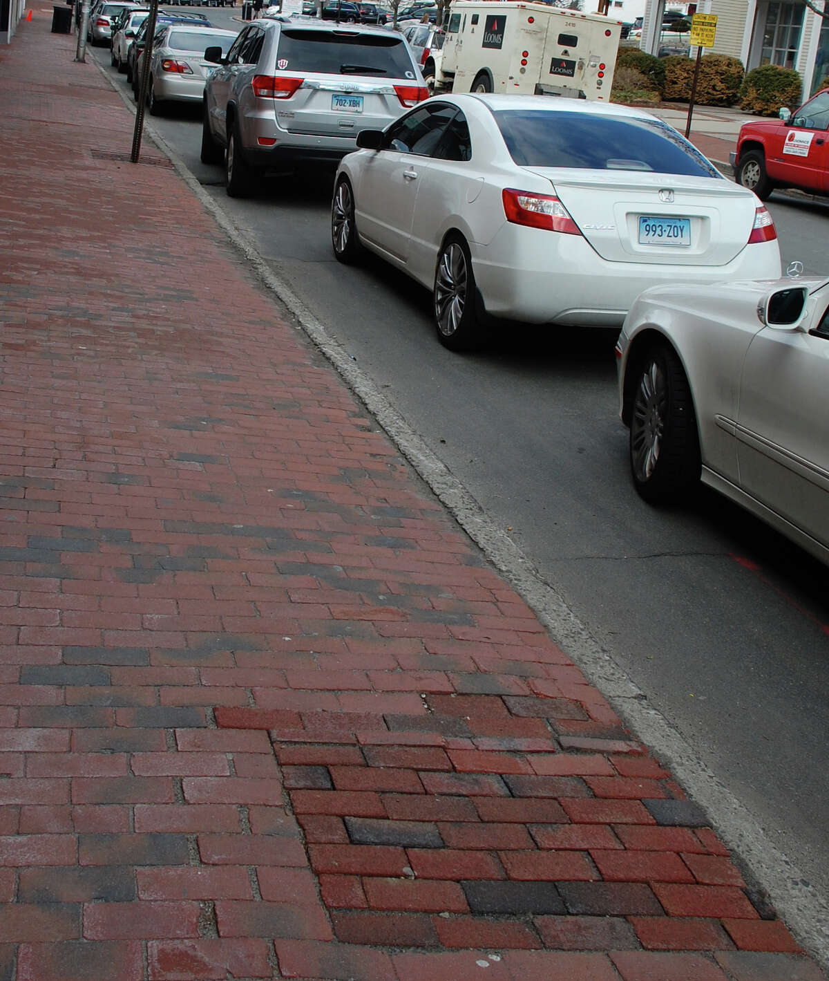 Newer bricks in Main Street sidewalks mark the spots where trees were removed --- without the required permission, according to a new report by the Westport Tree Board.
