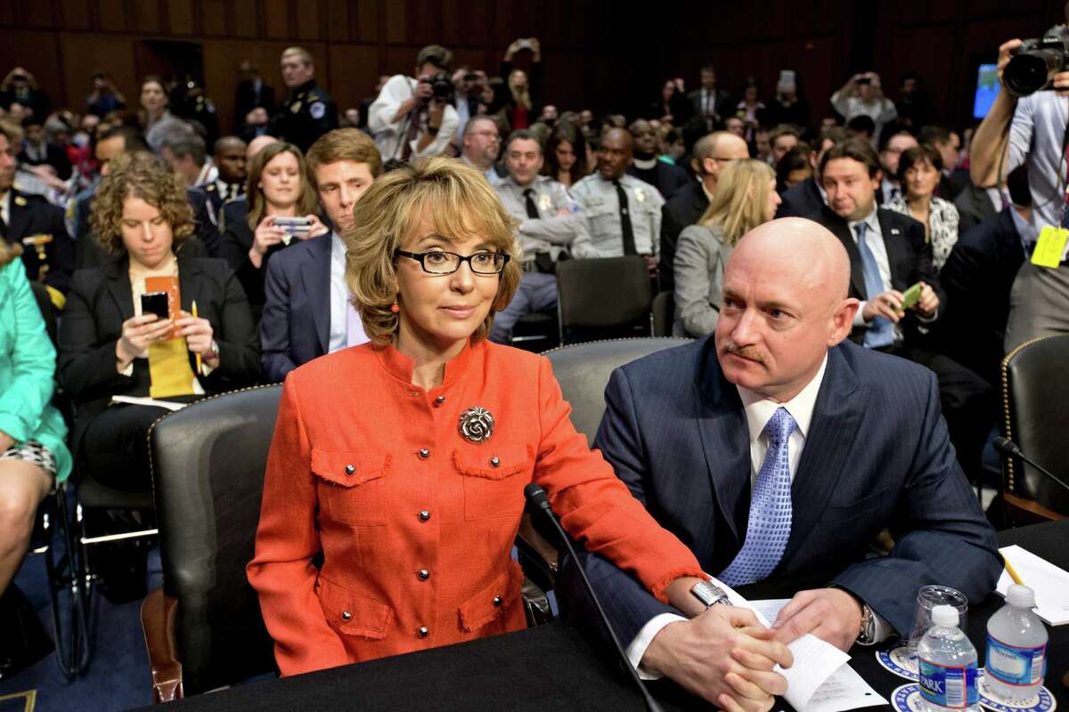 Former Arizona Rep. Gabrielle Giffords, who was seriously injured in the mass shooting that killed six people in Tucson, Ariz., two years ago, sits with her husband, Mark Kelly, a retired astronaut, prior to speaking before a Senate hearing in January on what lawmakers should do to curb gun violence.