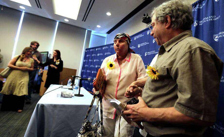 Sheldon Stein, right, holds the hand of his girlfriend Carmen Blandin Tarleton of Thetford, Vermont, following a press conference at the Brigham and Women's Hospital in Boston, Massachusetts on Wednesday, May 1, 2013. The mother of 44 two had the transplant in February after an attack in 2007 during which her ex-husband sprayed her with industrial laundry, burning more than 80% of her body. (AP Photo / Charles Krupa) Photo: Charles Krupa, STF / AP