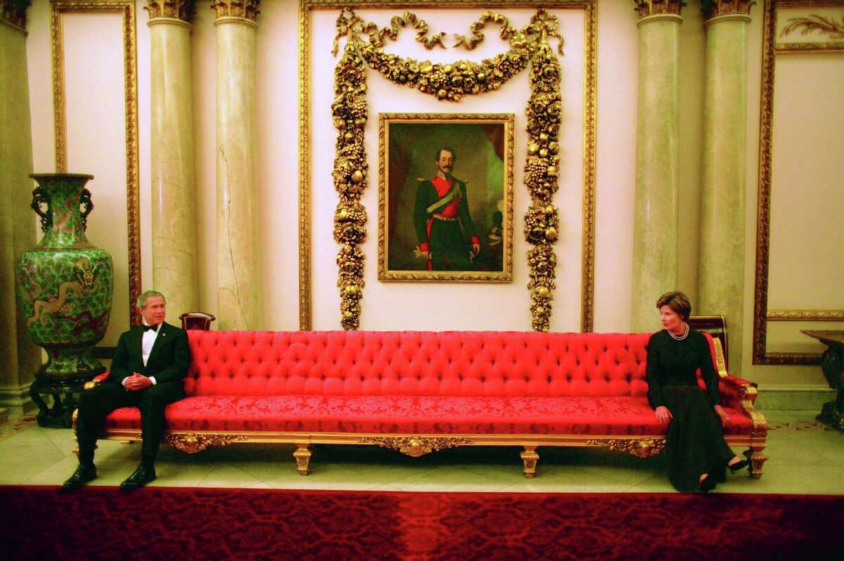 President George W. Bush and Mrs. Laura Bush sit on either ends of a couch prior to a social event at Buckingham Palace. Photo by Eric Draper, Courtesy of the George W. Bush Presidential Library and Museum