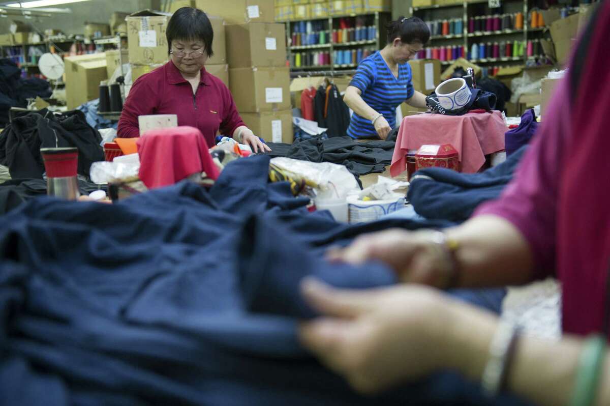 Workers perform quality control on American Giant sweatshirts inside the SFO Apparel Co. in Brisbane, Calif. The productivity of U.S. workers rose at a seasonally adjusted annual rate of 0.7 percent in the January-March quarter.