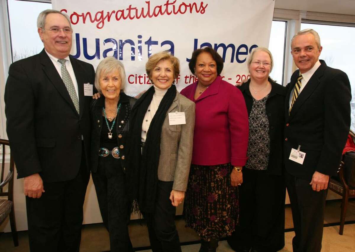 Juanita James (third from right) stands with past Stamford Citizens of the Year Richard Taber '08, June Rosenthal '07, Sandy Goldstein '05, Polly O'Brien Morrow '99, and Michael Cacace '95 during Ms. James Surprise party at the World Headquarters of Pitney Bowes in Stamford.