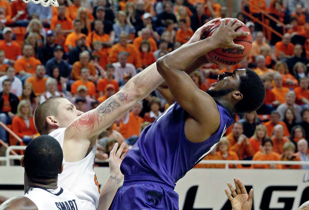 Oklahoma State forward Philip Jurick, left, fouls Kansas State forward Nino Williams as he shoots in the second half of an NCAA college basketball game in Stillwater, Okla., Saturday, March 9, 2013. Oklahoma State won 76-70. (AP Photo/Sue Ogrocki)