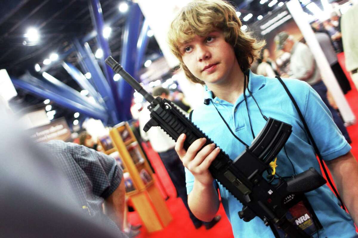 James Beaver, 13, of Denison holds a HK 416 D while learning about the NRA's Whittington Center Outdoor Adventure Camp