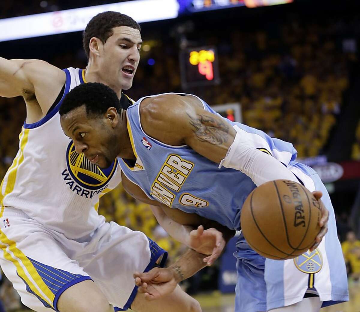Denver Nuggets' Andre Iguodala, right, is defended by Golden State Warriors' Klay Thompson during the second half of Game 6 in a first-round NBA basketball playoff series in Oakland, Calif., Thursday, May 2, 2013. Golden State won 92-88. (AP Photo/Marcio Jose Sanchez)
