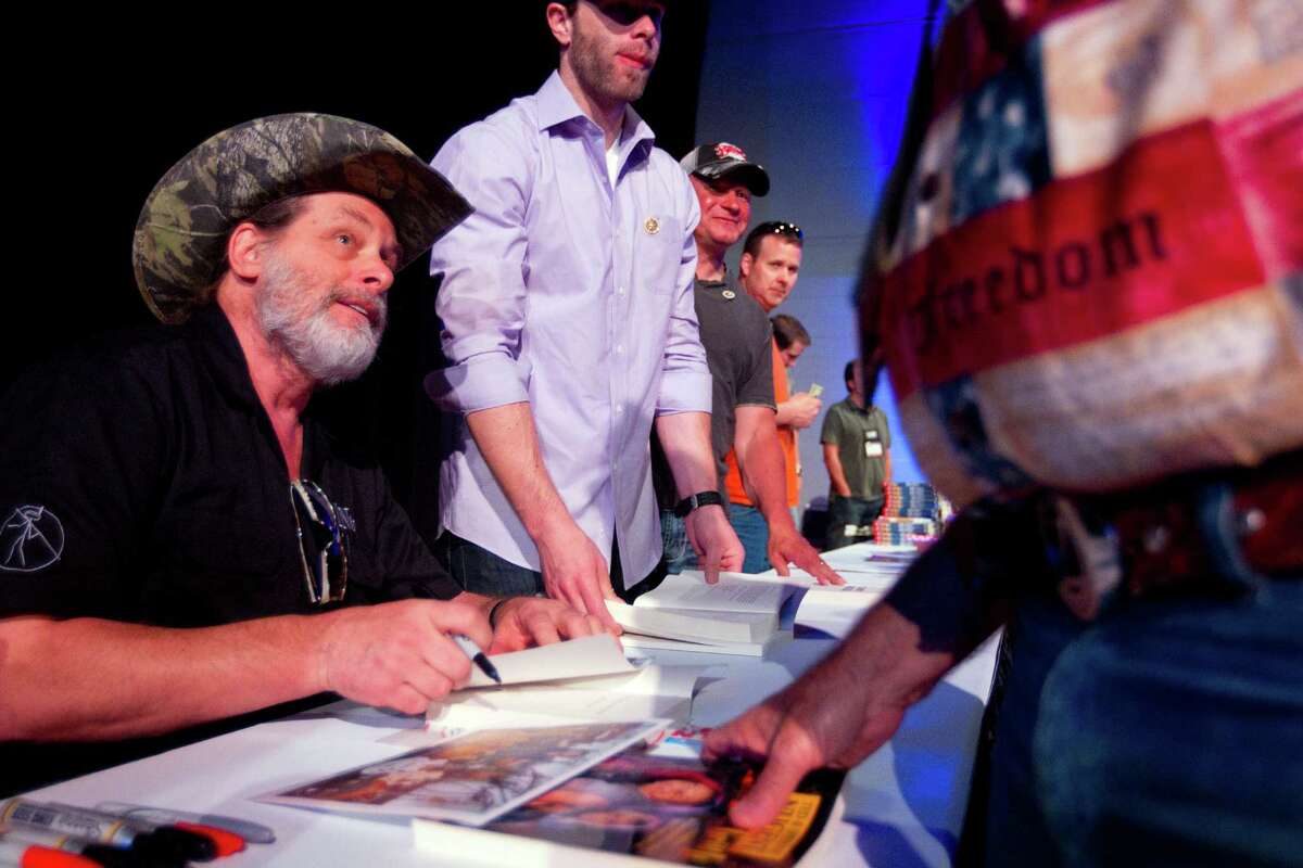 NRA member and musician, Ted Nugent, greets fans and signs autographs at the National Rifle Association's 142 Annual Meetings and Exhibits in the George R. Brown Convention Center Sunday, May 5, 2013, in Houston. The 2013 NRA Annual Meetings and Exhibits runs through Sunday, May 5. More than 70,000 are expected to attend the event with more than 500 exhibitors represented. The convention will features training and education demos, the Antiques Guns and Gold Showcase, book signings, speakers including Glenn Beck, Ted Nugent and Sarah Palin as well as NRA Youth Day on Sunday