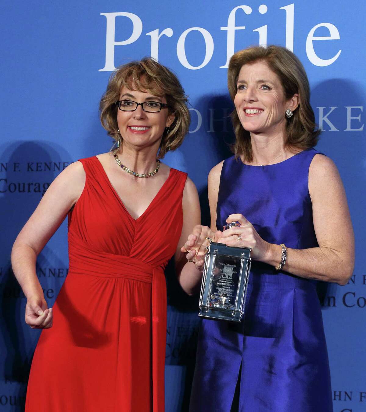 Caroline Kennedy (right) displays the 2013 Profile in Courage award she had just presented to former U.S. Rep. Gabrielle Giffords (left) at the John F. Kennedy Library in Boston.