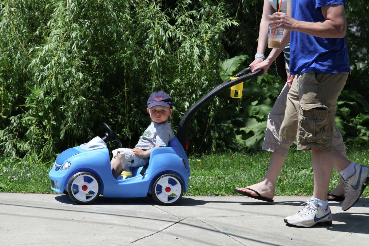 Logan Ames, of Hamden, goes for a car ride with his parents, Lauren Sardi and Todd Ames, in downtown Milford on Sunday, June 2, 2013.