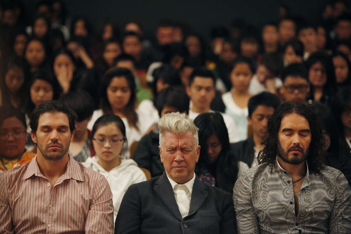 Barry Zito (l to r), of the San Francisco Giants; director David Lynch and actor Russell Brand meditate with students during the 6th anniversary celebration of the San Francisco Unified School District Quiet Time program at Phillip and Sala Burton Academic High School in San Francisco, Calif., on Monday May 6, 2013.