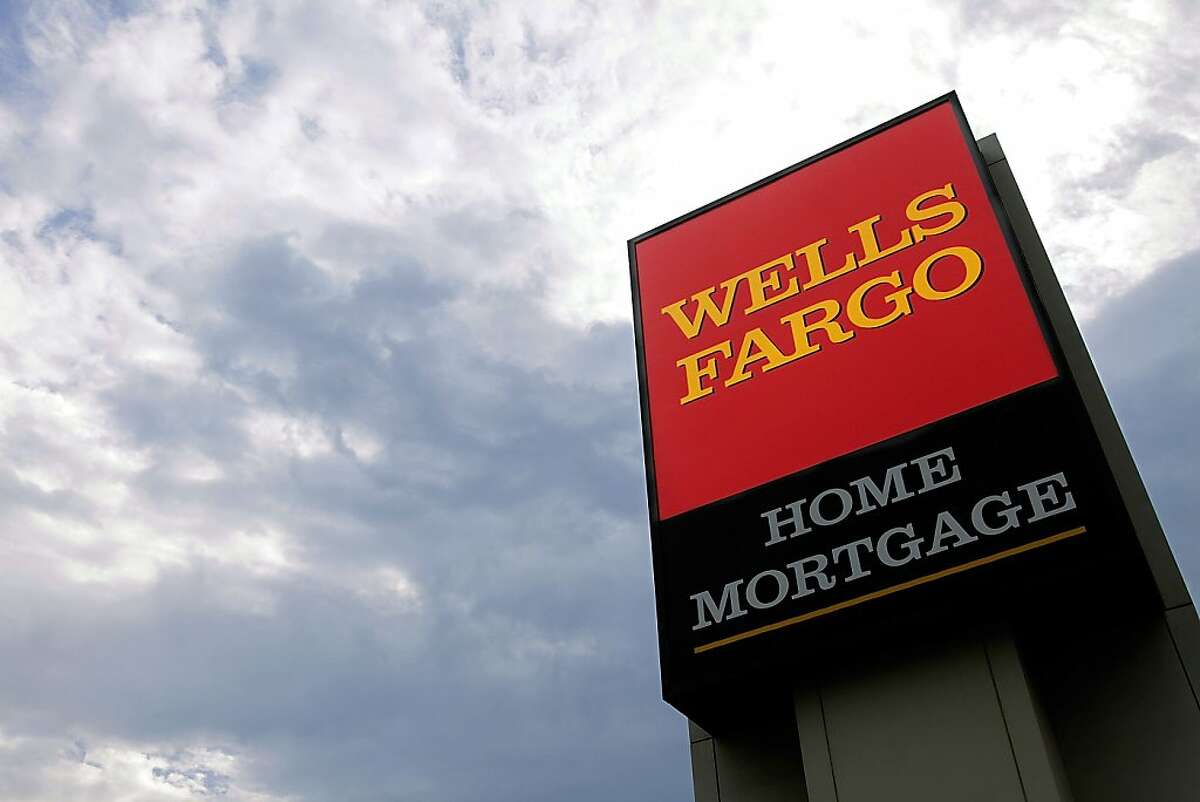 In this photograph taken July 19, 2010, the Wells Fargo logo is displayed on a sign outside one of the company's office buildings in Springfield, Ill. Wells Fargo & Co. said Wednesday, July 21, its second-quarter profit rose 21 percent as the growth of souring loans eased and it wrote off fewer defaults.