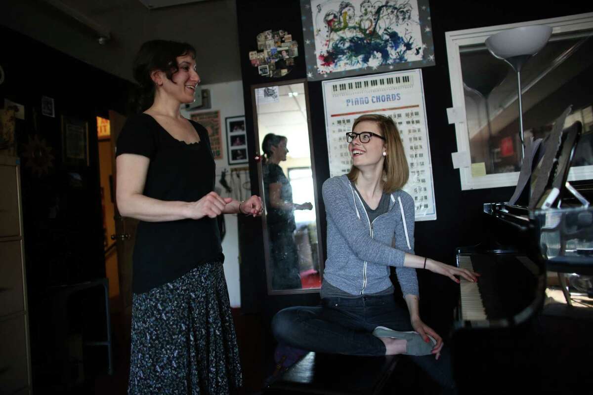 Voice teacher Lorrie Ruiz, left, works with student Heather Newton during a lesson at the Seattle Drum School in north Seattle on May 4, 2013.