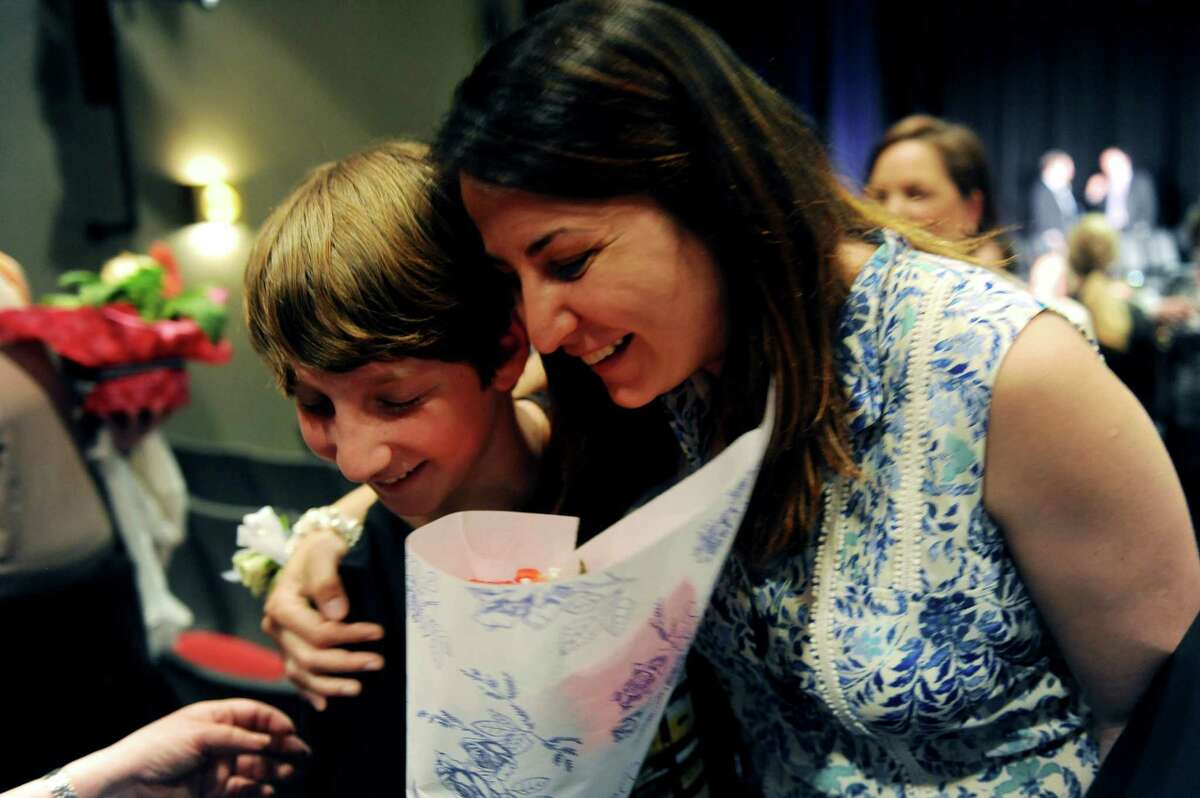Michael Blieberg, a student of Eastern Middle School gave flowers to a distinguished teacher Esra Murray, for his favorite teacher during the Distinguished Teachers Awards at Western Middle School, in Greenwich, Tuesday, May 7, 2013.