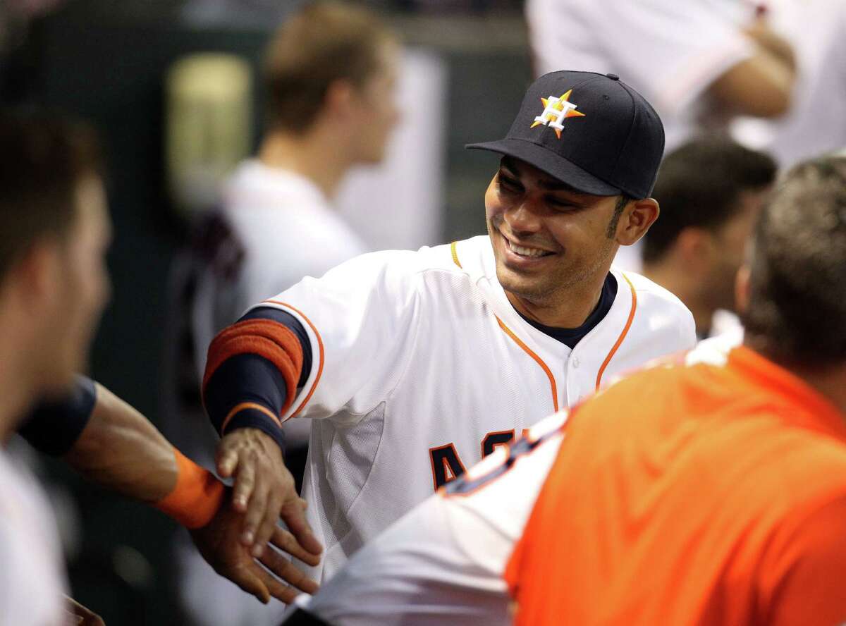 Astros first baseman Carlos Pena tries to keep spirits up in the dugout while sitting out Tuesday night's game at Minute Maid Park.