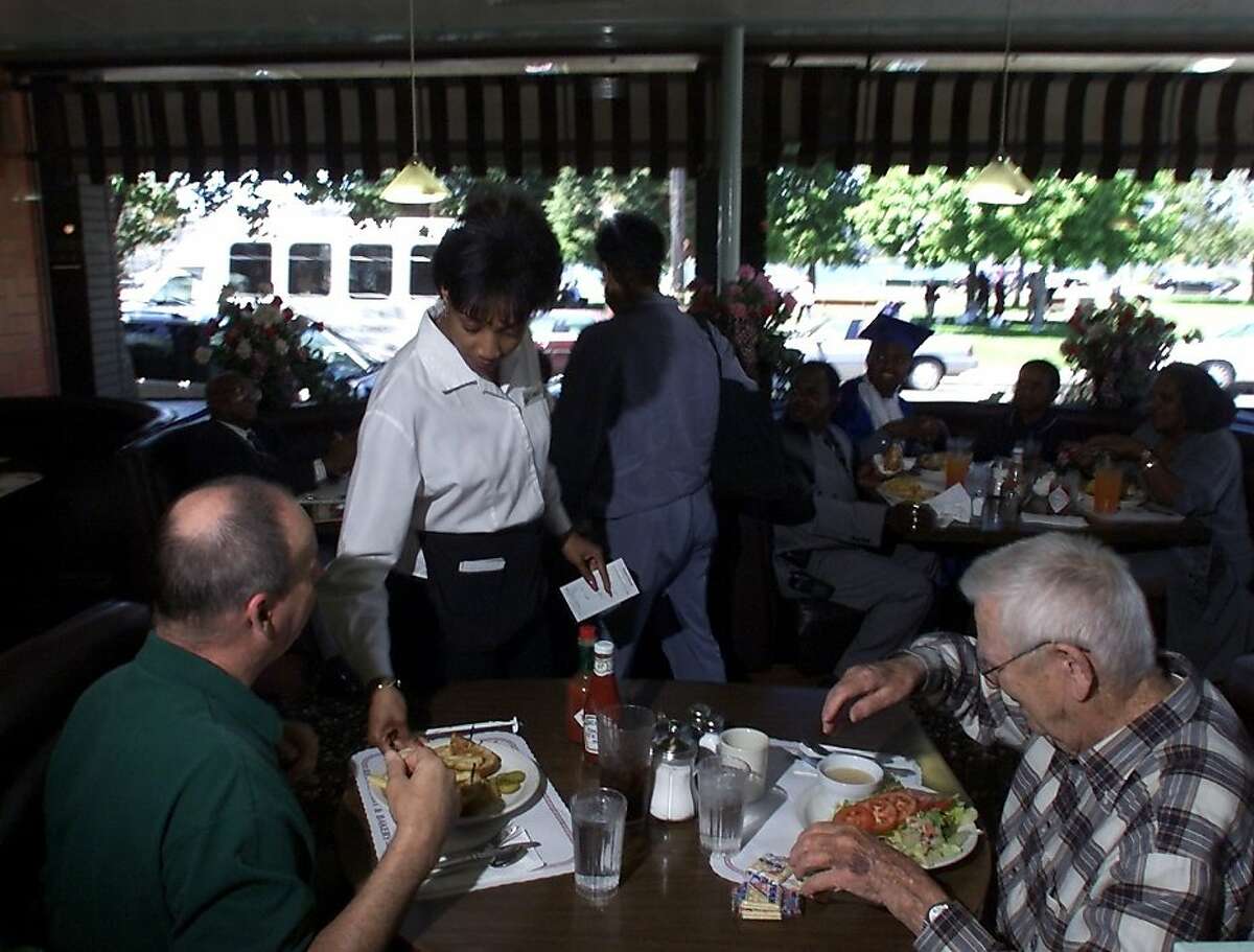 Gail Bennett serves lunch to Dan Foley and Bob Lawton at Oakland's Merritt Restaurant on East 18th street.