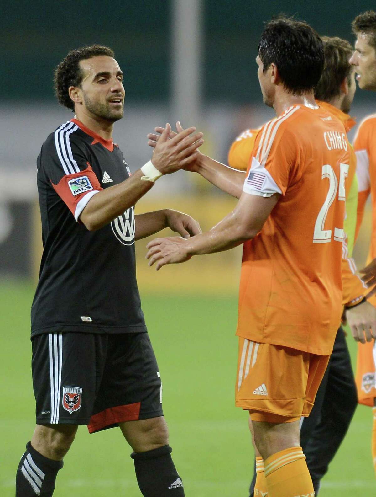 D.C. United midfielder Dwayne De Rosario (7) greets his former Houston Dynamo teammate Brian Ching (25) following the match at RFK Stadium in Washington, D.C., Wednesday, May 8, 2013. Dynamo blanked United, 4-0. (Chuck Myers/MCT)