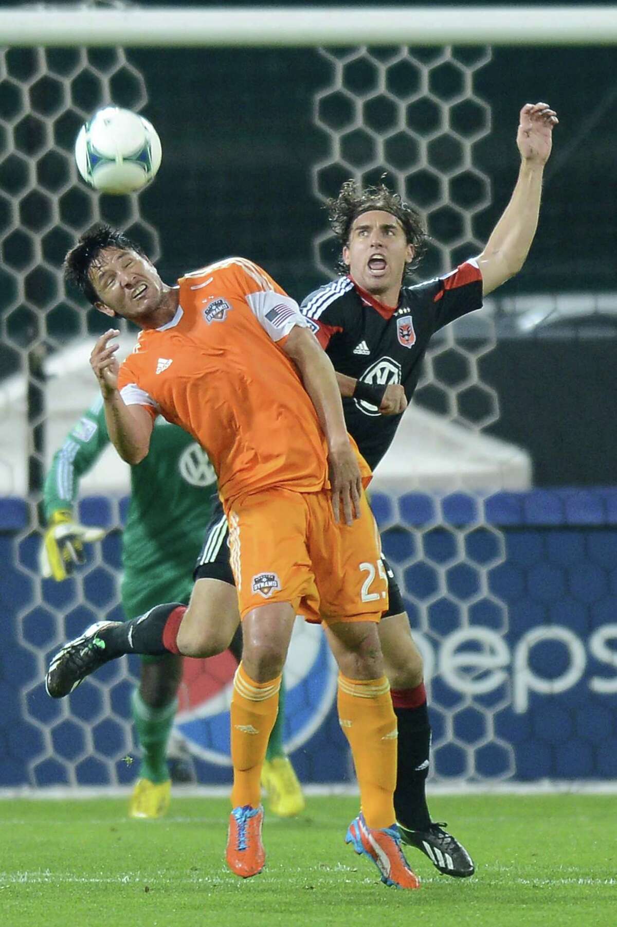 Houston Dynamo forward Brian Ching (25) and D.C. United defender Dejan Jakovic (5) battle for a head ball in the second half at RFK Stadium in Washington, D.C., Wednesday, May 8, 2013. Dynamo blanked United, 4-0. (Chuck Myers/MCT)