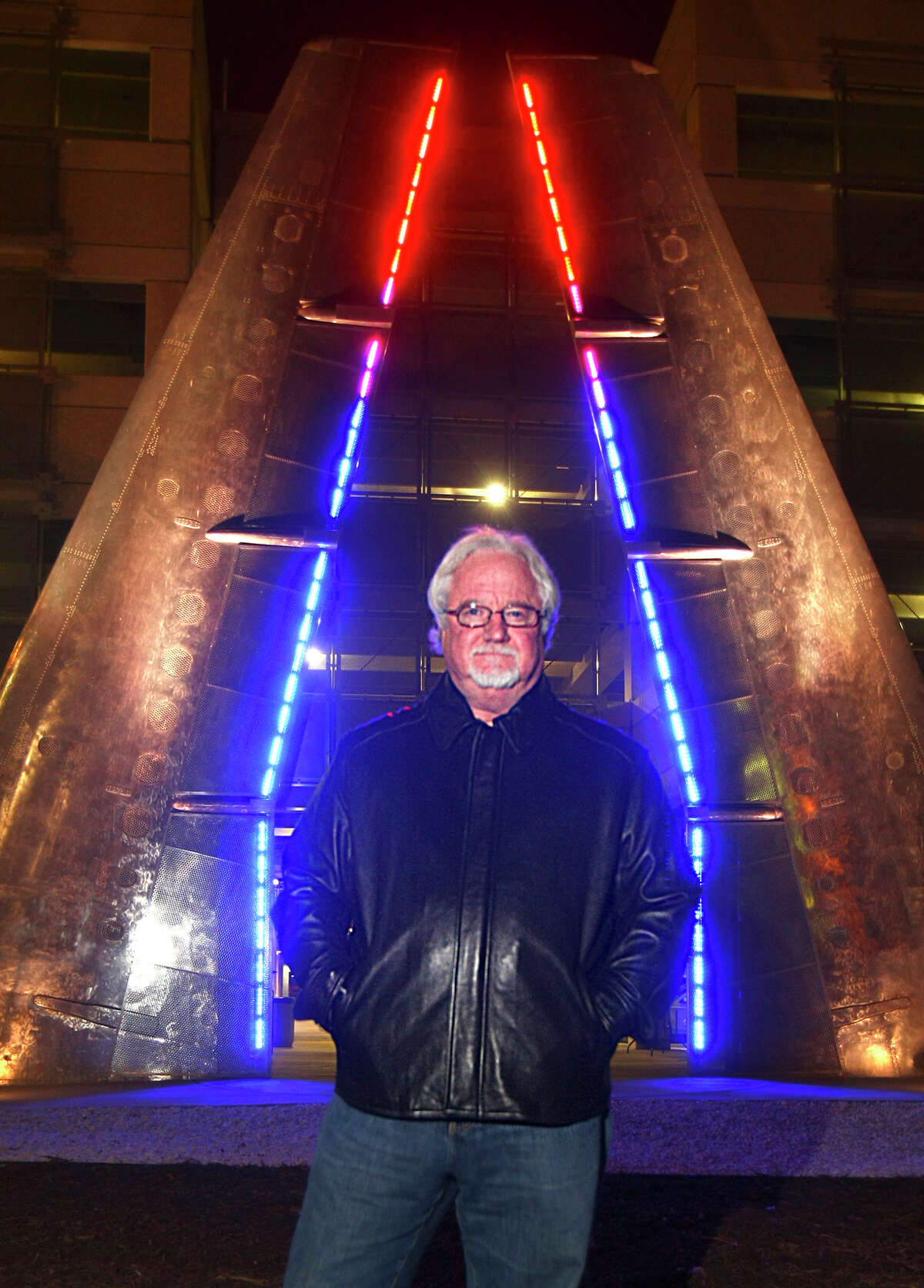 Artist Bill FitzGibbons poses Tuesday night Dec. 17, 2008 in front of one of the pieces of public art he created at the San Antonio International Airport.