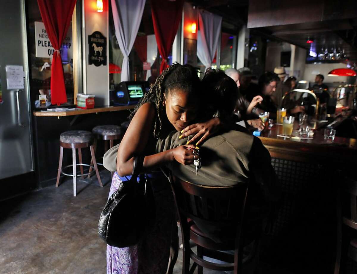 Danielle Anderson hugs another bar patron (who declined to be identified) at the White Horse Tavern in Oakland, Calif., on Tuesday, May 7, 2013. The bar is thought to be the oldest gay bar in the country and turns 80 this week. Some of the regulars have been frequenting the bar since the 40s.