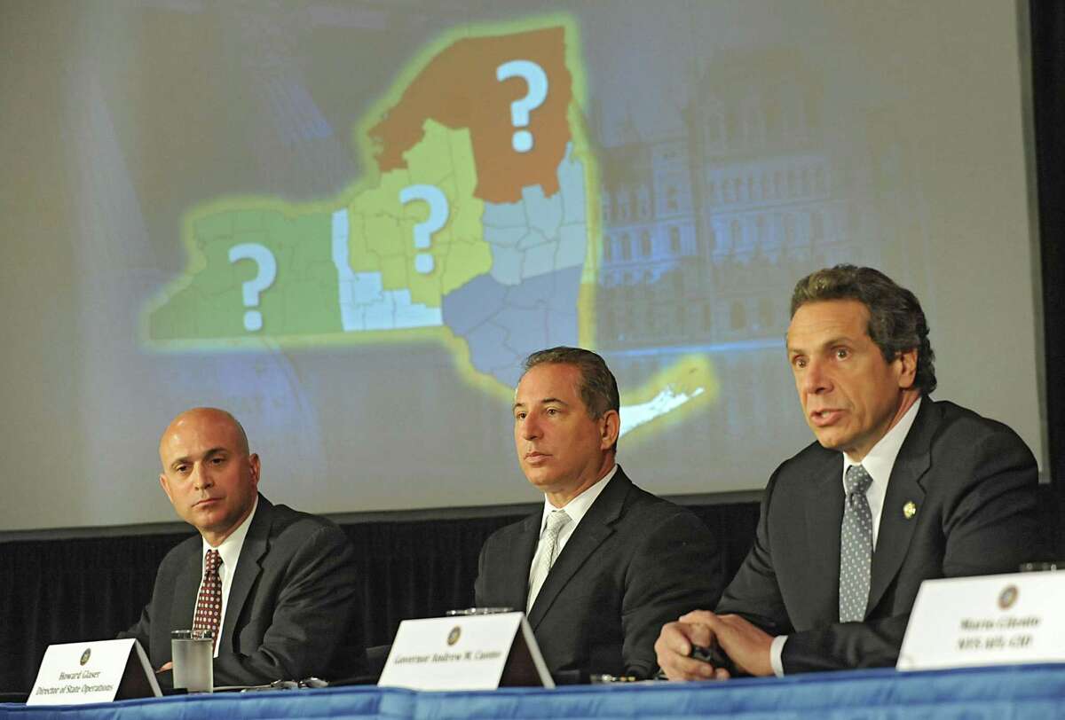 Governor Andew Cuomo, right, holds a press conference to discuss proposals on upstate casinos on Thursday, May 9, 2013 in Albany, N.Y. Also sitting with the governor are Steve Acquario, NYS Association of Counties, left, and Howard Glaser, Director of State Operations. (Lori Van Buren / Times Union)